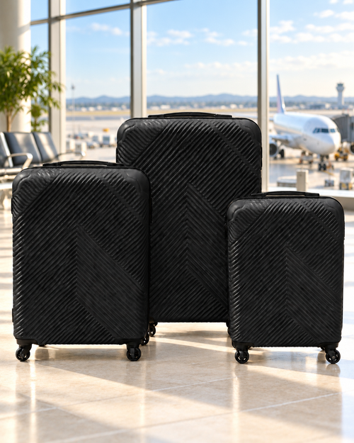 Three black textured suitcases displayed at an airport