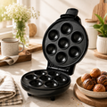 Cake maker with multiple baking cavities for preparing mini cakes and sweet treats at home.