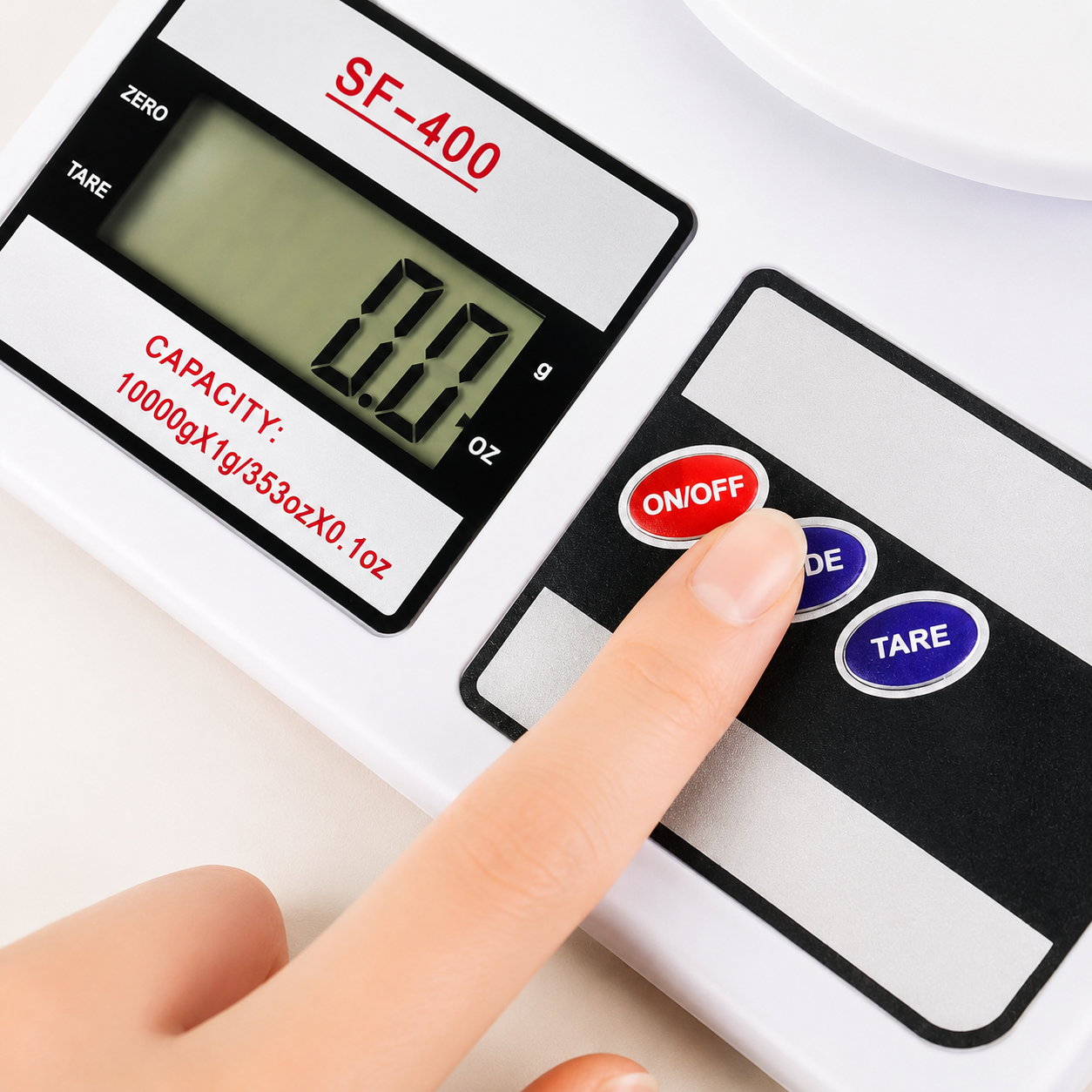 Close-up of the SF-400 digital kitchen scale showing the LCD display and on/off, mode, and tare buttons for accurate food weighing.