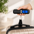 Digital luggage scale weighing a suitcase before travel