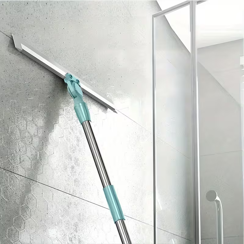 Floor squeegee cleaning water from a bathroom shower glass panel.