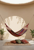 Colourful hammock with wooden spreader bars for garden, patio and outdoor relaxation