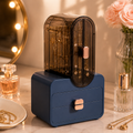 Blue jewelry organizer with transparent hanging compartment and two storage drawers displayed on a modern vanity table.