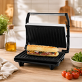 Panini maker with dual grilling plates for preparing paninis, toasted sandwiches, and grilled snacks.