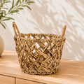 Round woven storage basket with integrated handles for organizing towels, clothing, toys, books, magazines, and household essentials.